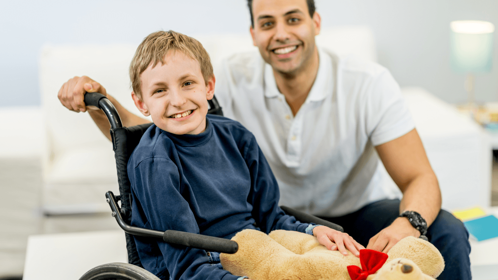 Child in wheelchair with caregiver